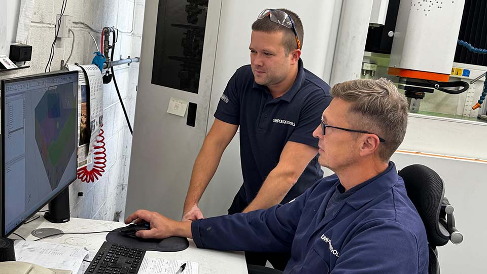 ComplexaHPE personnel Will Ramsey (standing) and Neil Russell discuss a project.