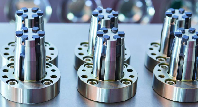 Precision spring steel lifters, manufactured with Cimatron, shown slightly forward in 8-cavity pill vial cap mold
